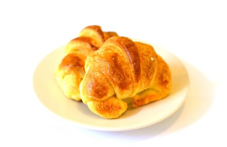  two fresh croissant ,casting soft whadow on white. の写真素材