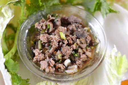 Thai dish of spicy minced pork eaten with vegetableの写真素材