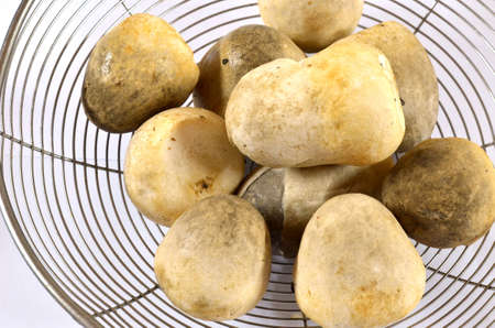 fresh straw mushrooms  on sieveの写真素材