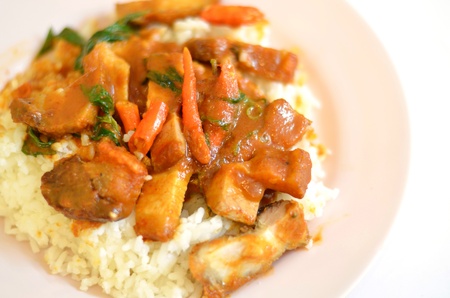 Stir fried crispy pork with red curry paste and riceの写真素材