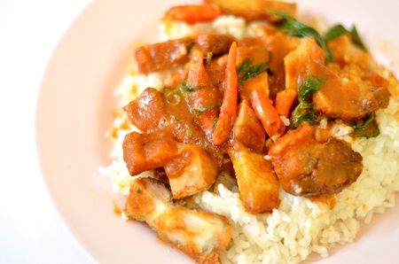 Stir fried crispy pork with red curry paste and riceの写真素材