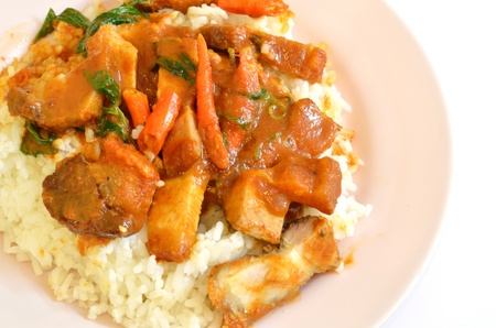 Stir fried crispy pork with red curry paste and riceの写真素材