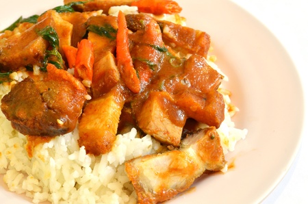 Stir fried crispy pork with red curry paste and riceの写真素材