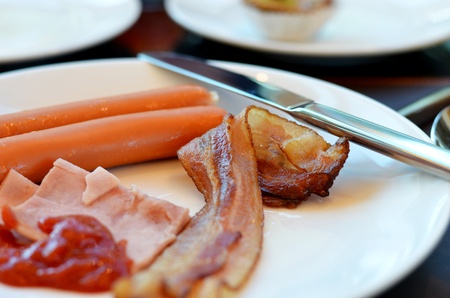 Breakfast with bacon, ham , sausage and  tomato sauceの写真素材