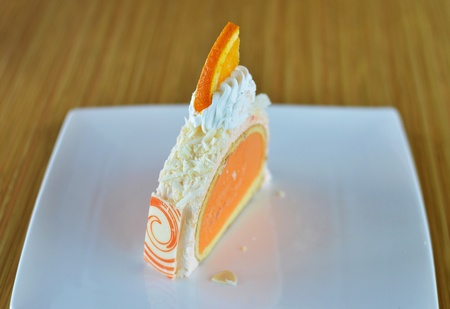 orange ice cream cake with whipped creamの写真素材