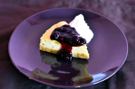 a slice of blueberry cheese cake served with whipped creamの写真素材