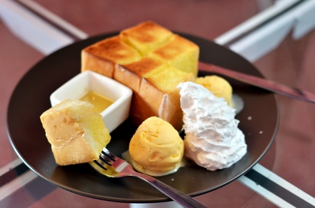 toast and whipping cream with vanilla ice cream served with honey sauceの写真素材