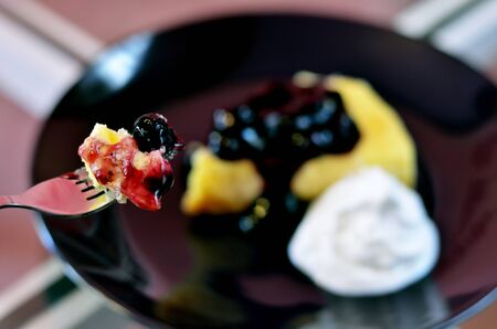 close-up of blueberry cheese cake on forkの写真素材