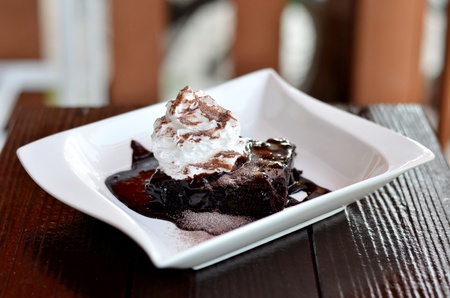 brownie cake served with chocolate sauce and whipped creamの写真素材