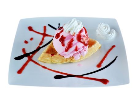 Waffle and whipping cream with strawberry ice creamの写真素材
