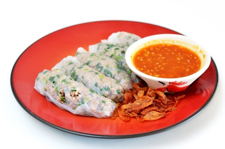 Vietnamese rice noodle rolls with a filling of pork sliced and vegetable ,  fried onion served with spicy sauceの写真素材