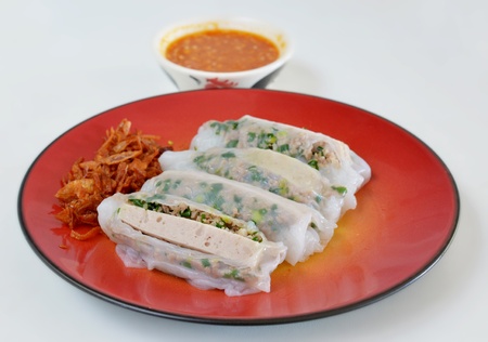 Vietnamese rice noodle rolls with a filling of pork sliced , vietnamese sausage and vegetable served with  fried onion and spicy sauceの写真素材