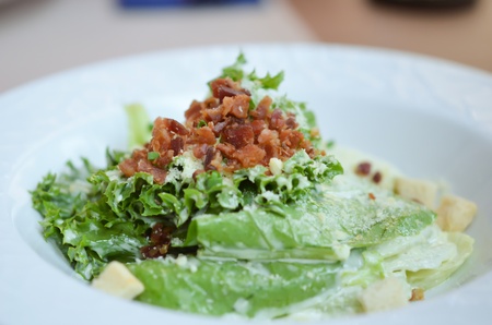 white bowl of caesar salad , fresh and deliciousの写真素材