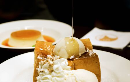 toast with whipping cream ,  ice cream  and honey syrupの写真素材