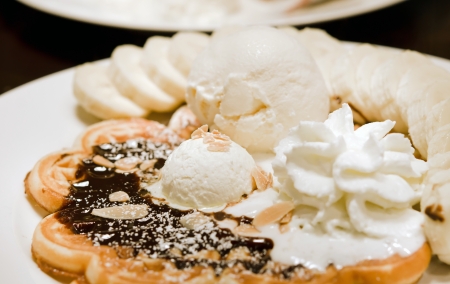 vanilla ice cream waffle with bananas and whipping creamの写真素材