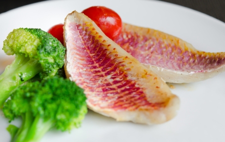 fish dish with fresh vegetable on white dish