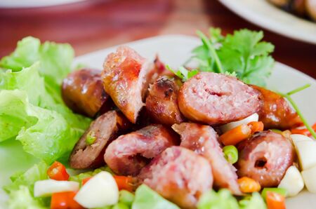Thai Style Sausage served with chili , garlic and fresh vegetableの写真素材