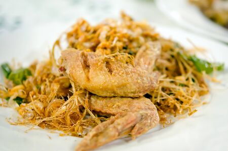 deep fried  chicken  with fried herb on plateの写真素材