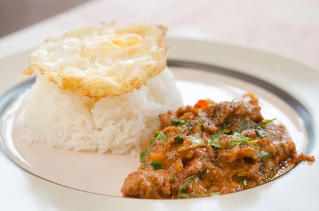 fried egg over rice and pork fried with chili pepper and   curry sauce , asian mealの写真素材