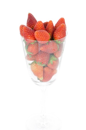 ripe  strawberry full in glass on white backgroundの写真素材