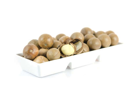 close up macadamia in  white bowl  over  white の写真素材