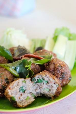 close up meatballs with fried  bergamot leaves and fresh vegetableの写真素材