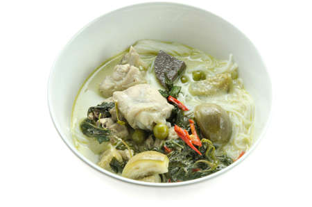 green chicken curry served with  rice vermicelli in white bowlの写真素材