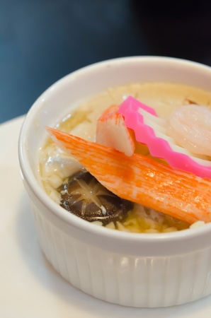 chinese steamed egg with seafood and mushroom in white bowlの写真素材