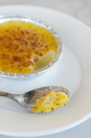 close up caramelized custard with silver spoon ,  creme bruleeの写真素材