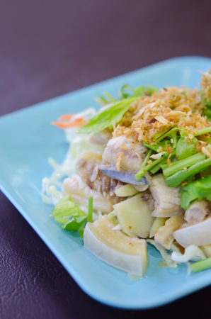 close up steamed fish with fried garlic and fresh vegetableの写真素材
