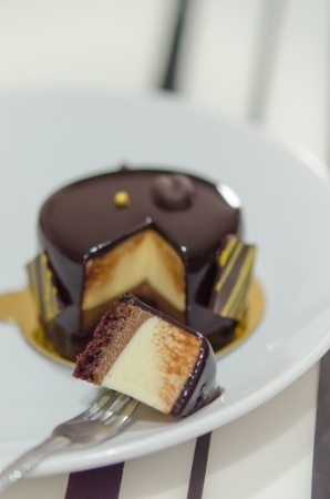 Coffee mousse cake with  dark chocolate , sweet dessert with fork on dish   selective focus の写真素材