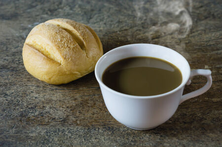 hot coffee with fresh bread on wooden  ,  still life