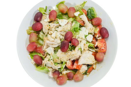 top view Mix salad with grapes and chicken on white dish over white backgroundの写真素材