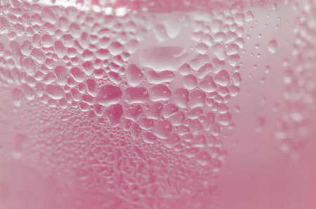 Water droplets on the glass with a colored background. Drops of water.の写真素材