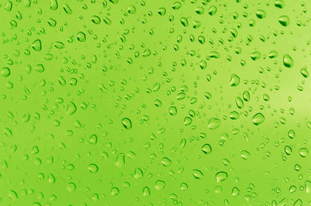 Water droplets on the glass with a colored background. Drops of water.の写真素材