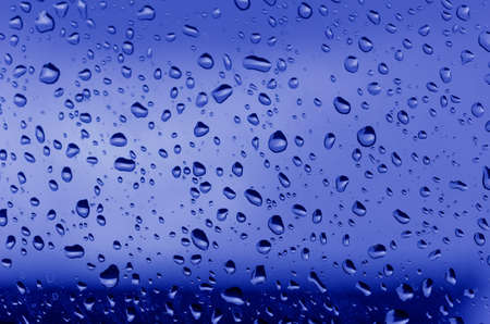 Water droplets on the glass with a colored background  Drops of water の写真素材