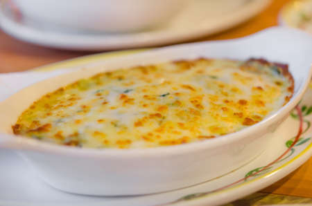 close up Baked spinach with cheese in white bowlの写真素材