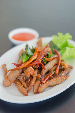Closeup of fresh fried meat with sesame and chiliの写真素材