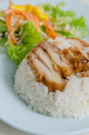 close up fried Chicken over steamed rice on plateの写真素材