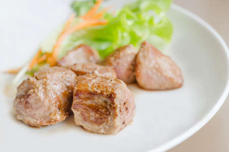 grilled pork meat with fresh salad on a plateの写真素材