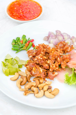 Deep fried sour fermented chicken knees tendon served with vegetables  slicedの写真素材