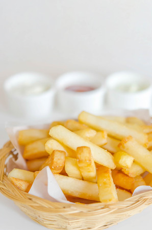 Traditional French fries in a bamboo basket