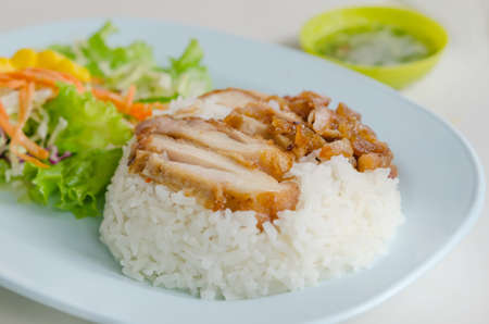 close up fried Chicken over steamed rice on plateの写真素材