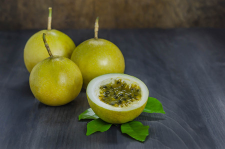 Fresh passion fruit and half over wooden background , still lifeの写真素材