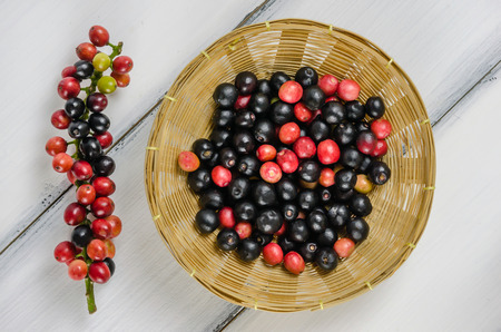 Top view Thai Blueberry in bamboo basket over wooden backgroundの写真素材