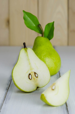 One and a half green pears over white backgroundの写真素材
