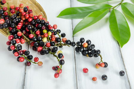 Thai Blueberry in bamboo basket over wooden background , still lifeの写真素材