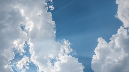 White fluffy clouds on a blue sky backgroundの写真素材