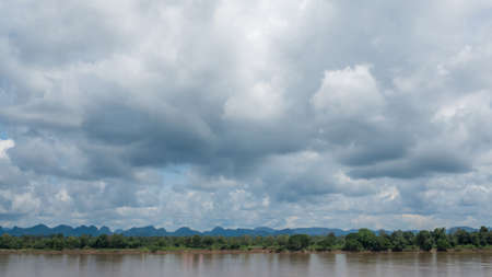 White fluffy clouds on a blue sky backgroundの写真素材