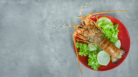 Top view of steamed lobster with fresh vegetable on plateの写真素材